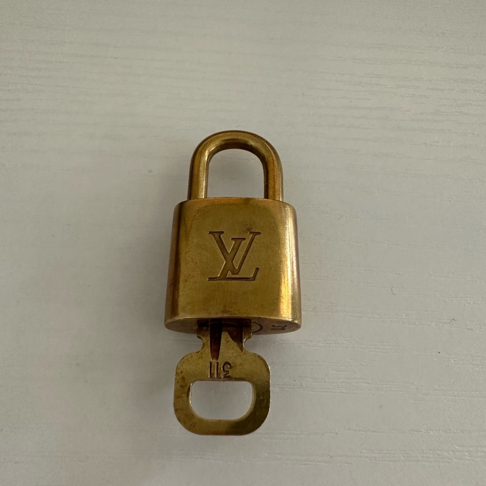 #311 Louis Vuitton authentic padlock and key.